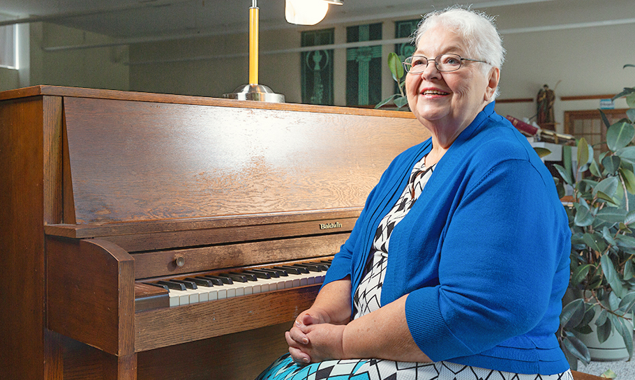 woman sitting on piano bench